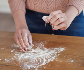 a woman's hand pours wheat flour. baker's hand closeup. Cooking pizza, bread during coronavirus