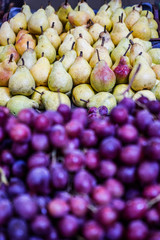 Pears and grapes are placed on a shelf in the market