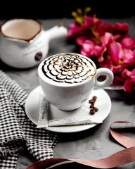 a cup of cappuccino with chocolate syrup flower latte-art