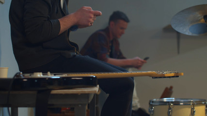 Musicians relax after rehearsal playing on the phones