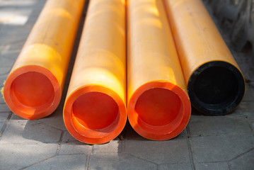 Orange plastic long pipe on the street