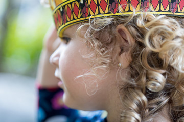 Portrait of a little girl wearing a crown - playing