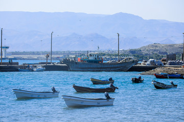 Fototapeta na wymiar Tadjoura, Djibouti - November 09, 2019: Colorful Boats in the Tadjoura Bay Water