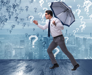 Uncertainty concept with businessman and question marks