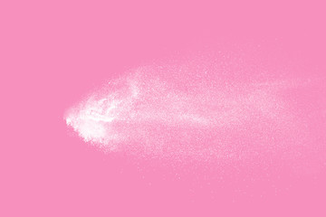 White powder explosion on pink background. Paint Holi.