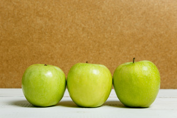 Three green apples. Side view. Healthy food, diet.