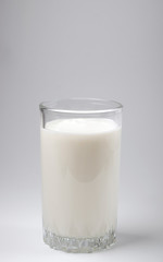 Kefir drink in a bottle and glass on a white background.Sour milk drink