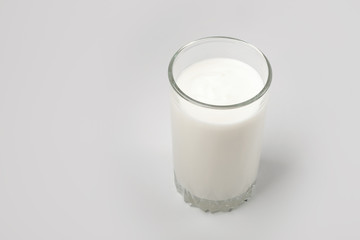 Kefir drink in a bottle and glass on a white background.Sour milk drink