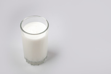Kefir drink in a bottle and glass on a white background.Sour milk drink