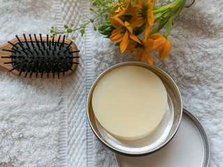 Solid, plastic free Shampoo bar in a round metal container