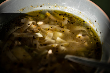 Chicken soup with noodles, potatoes and meat