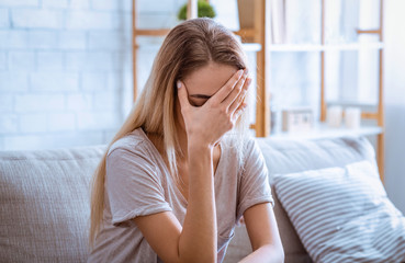 Sad woman covered face with hand. Stay alone at home