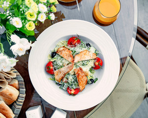 classic caesar salad with chicken and grated parmesan