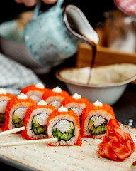 close up of sushi rolls with crab sticks cucumber and avocado