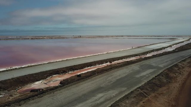 4K aerial drone video of salt works factory wide pink salty water evaporation ponds, in outskirts of coastal harbour town Walvis Bay, Namib Desert, Atlantic Ocean west coast, Namibia, southern Africa