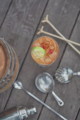 alcoholic cocktail with fruits on an old wooden table