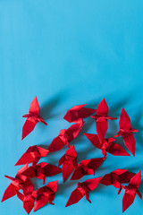 Red paper bird on a blue background,Origami, Paper Crane, Paper, Toy, Japan