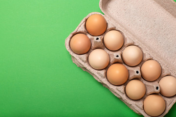 Egg tray on bright green background, copy space, top view.