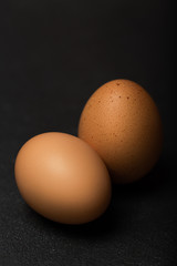 Eggs on black background,  selective focus, close up, deep shadows
