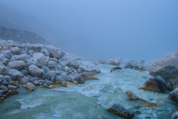 Mountain river in mist and fog