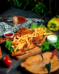 fried tobacco with fries on a wooden board