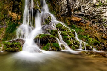 Beautiful Beusnita waterfall in the forest with green moss, Caras Severin county, National Park, Cheile Nerei, Bozovici, Romania