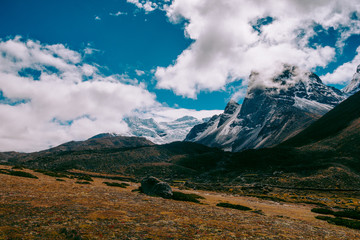 Beautiful mountain peaks and soft white clouds