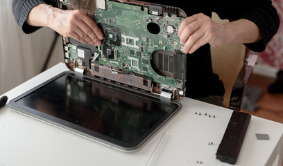 Laptop repair. Disassembled computer parts. PC electronic components. Closeup of keyboard, hdd, motherboard cpu