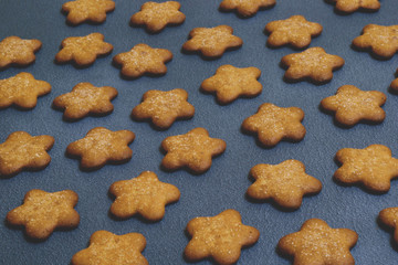 Cookies in the shape of stars on dark background. A place for your information. Cookies close up. Copy space. Selective focus.