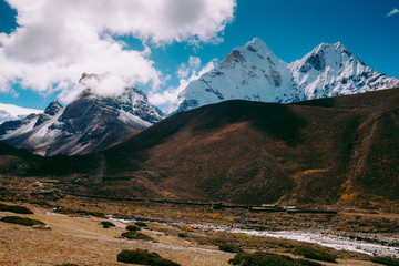 Beautiful mountain peaks and soft white clouds