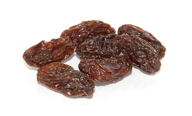 Dried raisins on white background.