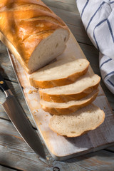 Sliced loaf of bread on a cutting board. Top view.