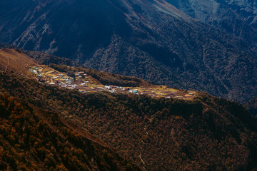 Mountain village and sun rays