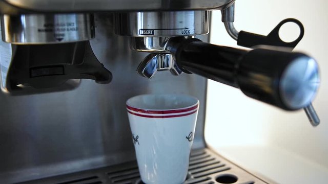 Hot espresso being extracted into a small cup, stock footage by Brian Holm Nielsen
