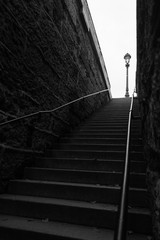 angled black and white shot of ascending stairs