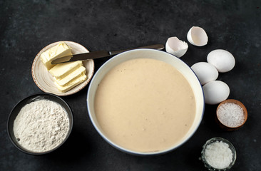 The recipe for making homemade pancakes from
flour, eggs, butter, milk, salt, sugar on a stone background with copy space for your text