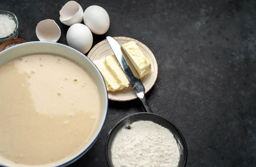 The recipe for making homemade pancakes from
flour, eggs, butter, milk, salt, sugar on a stone background with copy space for your text