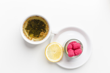 tea with lemon and raspberries on the table