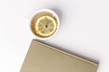 tea with lemon and a book on the table