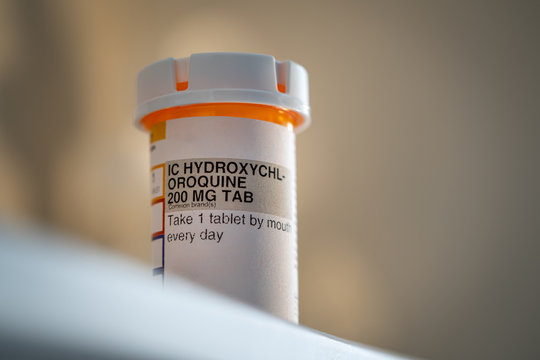 Hydroxychloroquine (Chloroquine) Pills, prescription bottle for possible (Unproven) Treatment To COVID-19. Generic drug for Plaquenil On white Background
