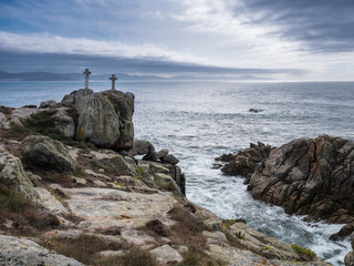 Fototapeta na wymiar Two crosses on a rock at Cape Roncudo in La Coruña, Galicia, Spain.