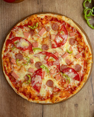 top view of pizza with sausages tomato bell pepper and cheese