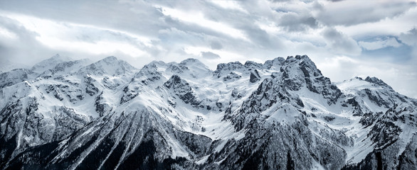 Panoramic view of snowy Caucasus mountain ridge in Karachayevo-Circassian Republic, Russia