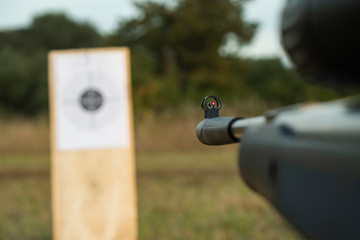 man shoots a rifle at a target