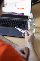 Fototapeta premium coronavirus danger COVID-19 epidemic outbreak quarantine concept of boy holding thermometer with high level of temperature