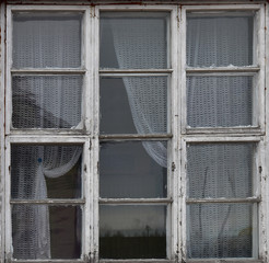 Old wooden window. Vintage frame texture with peeling paint.