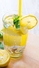 Glasss of mojito with lemon and drinking straw