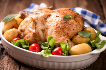 Roasted turkey garnished with potato and veg. Thanksgiving Christmas dinner. Chicken, roasted