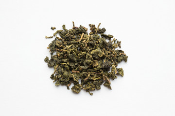 Green loose tea on a white background. Top view.