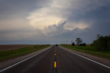 driving on the highway towards a storm